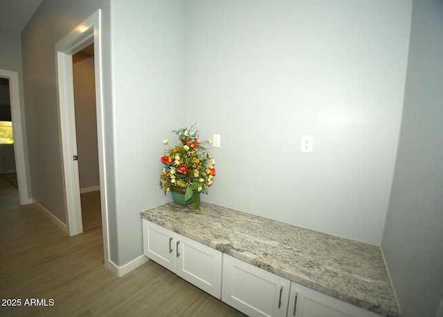 mudroom featuring light wood-type flooring and baseboards