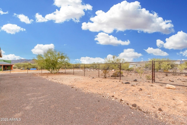 view of yard with a rural view and fence