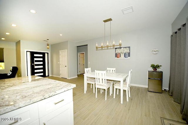 dining room with light wood-style floors, baseboards, and recessed lighting