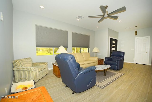 living area featuring recessed lighting, visible vents, baseboards, and wood finish floors