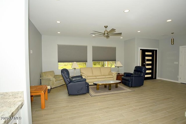 living area with light wood-style floors, recessed lighting, baseboards, and a ceiling fan