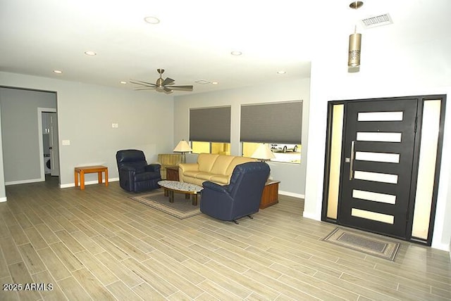 living area featuring visible vents, baseboards, ceiling fan, wood finish floors, and recessed lighting