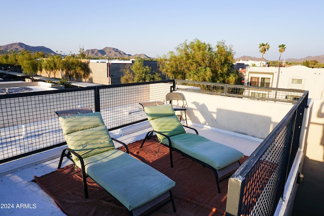 view of patio featuring a mountain view and a balcony