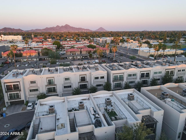 aerial view at dusk featuring a mountain view