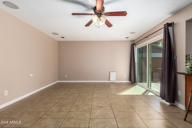 spare room featuring ceiling fan and light tile patterned floors