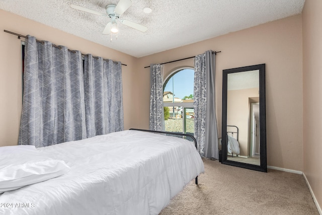 bedroom with a textured ceiling, ceiling fan, and carpet flooring