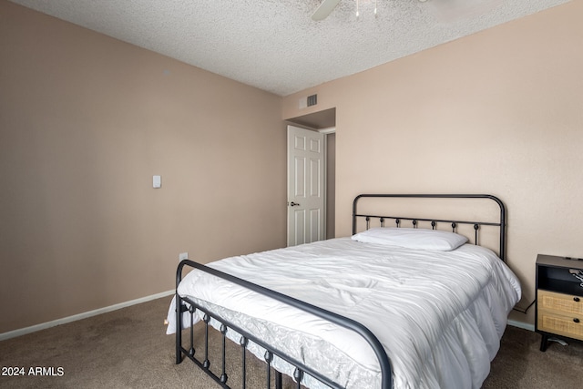 bedroom with carpet, a textured ceiling, and ceiling fan