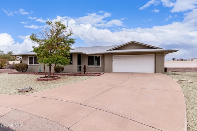 ranch-style home with a porch and a garage