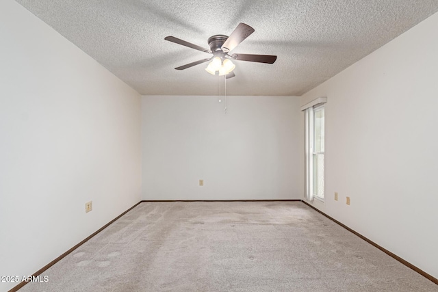 spare room with light carpet, ceiling fan, and a textured ceiling