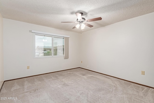 carpeted spare room featuring a textured ceiling and ceiling fan