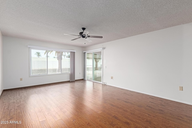 spare room featuring a textured ceiling, dark hardwood / wood-style floors, and ceiling fan