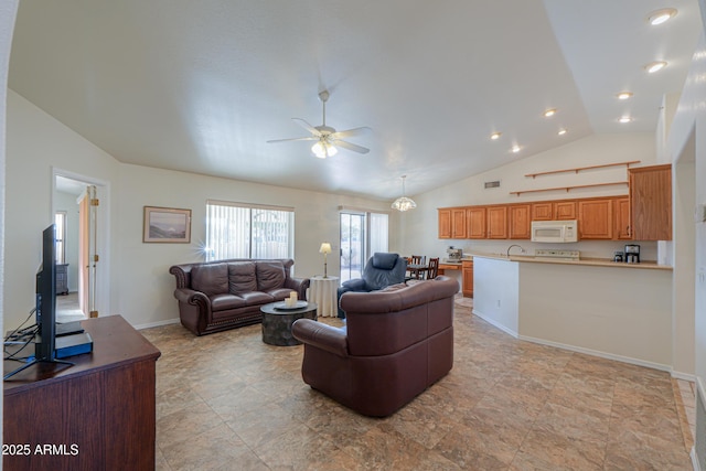 living room with ceiling fan and lofted ceiling