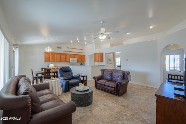 living room with ceiling fan and lofted ceiling