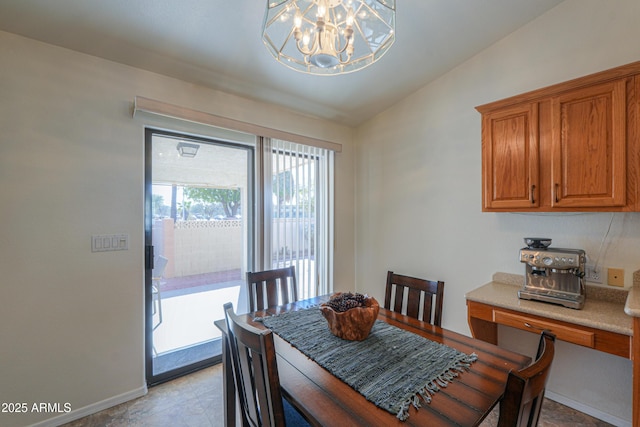 dining room with lofted ceiling and a chandelier