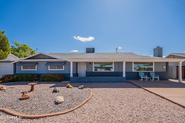 3109 N 81st St, Scottsdale, AZ 85251 - single story home with a chimney, covered porch, roof with shingles, and brick siding