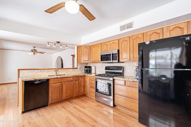 3109 N 81st St, Scottsdale, AZ 85251 - kitchen with black appliances, a ceiling fan, a sink, and decorative backsplash