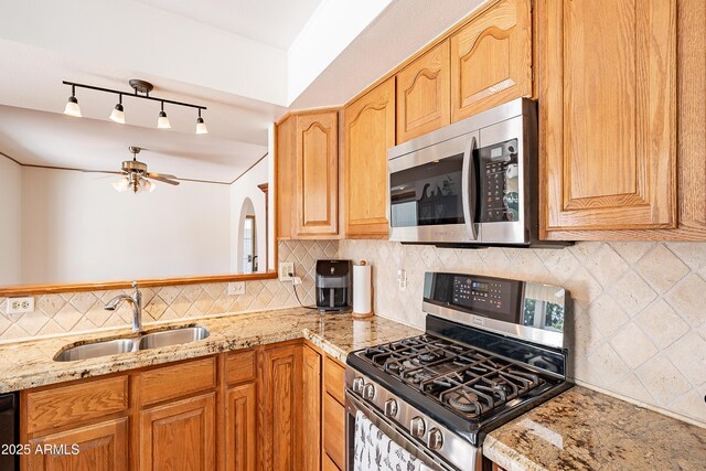 3109 N 81st St, Scottsdale, AZ 85251 - kitchen with stainless steel appliances, a sink, light stone counters, and backsplash