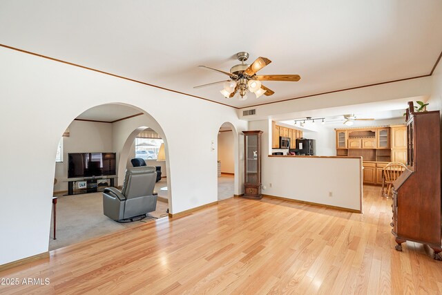 3109 N 81st St, Scottsdale, AZ 85251 - living room featuring ceiling fan, arched walkways, light wood-style flooring, and baseboards