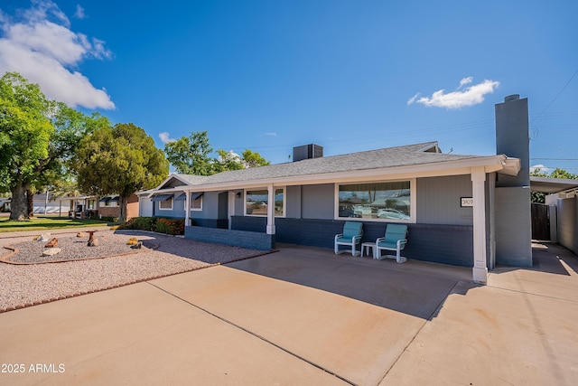 3109 N 81st St, Scottsdale, AZ 85251 - rear view of house featuring a chimney, a carport, roof with shingles, and concrete driveway