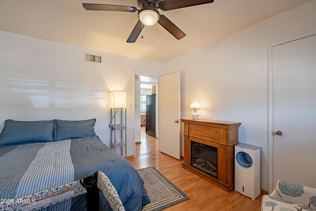 3109 N 81st St, Scottsdale, AZ 85251 - bedroom with light wood finished floors, freestanding refrigerator, and a ceiling fan