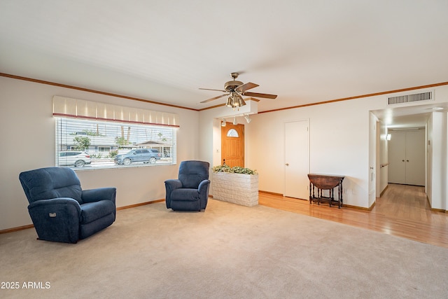 3109 N 81st St, Scottsdale, AZ 85251 - sitting room with carpet floors, ornamental molding, a ceiling fan, baseboards, and wood finished floors
