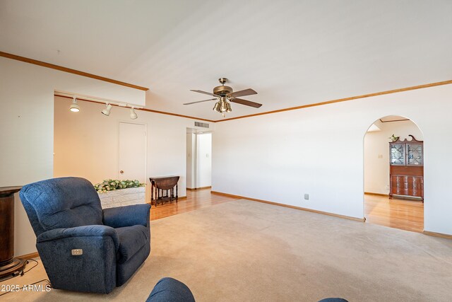 3109 N 81st St, Scottsdale, AZ 85251 - living area featuring light colored carpet, arched walkways, ceiling fan, track lighting, and baseboards