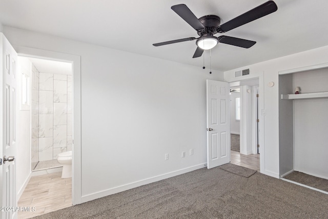 unfurnished bedroom with ceiling fan, carpet flooring, a closet, and ensuite bathroom