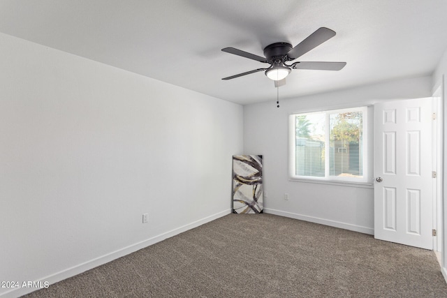 carpeted spare room featuring ceiling fan