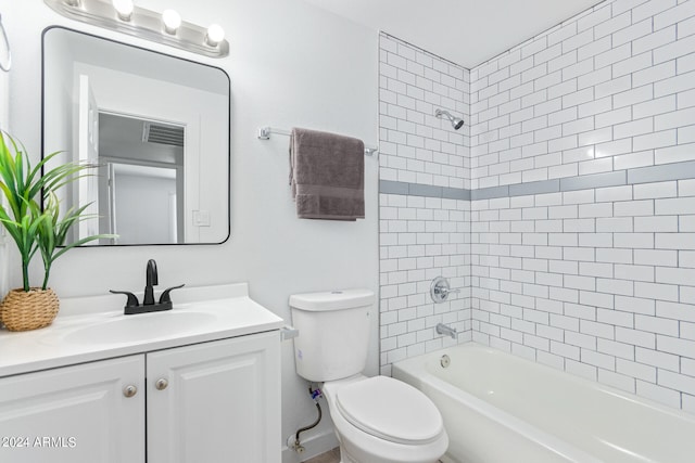 full bathroom featuring vanity, tiled shower / bath combo, and toilet