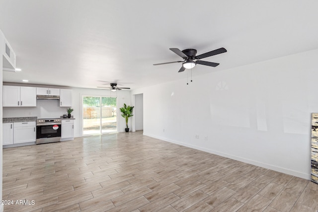 unfurnished living room with light wood-type flooring and ceiling fan