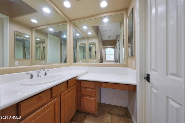 bathroom with stone finish floor, vanity, and recessed lighting