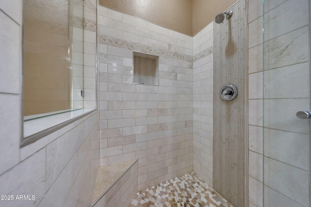 bathroom with a tile shower