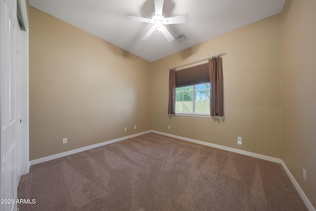 unfurnished room with a ceiling fan, carpet, visible vents, and baseboards