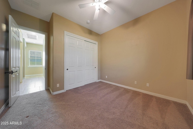 unfurnished bedroom with vaulted ceiling, carpet flooring, visible vents, and baseboards