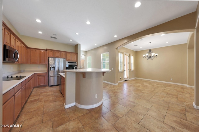 kitchen featuring a center island with sink, appliances with stainless steel finishes, light countertops, and recessed lighting