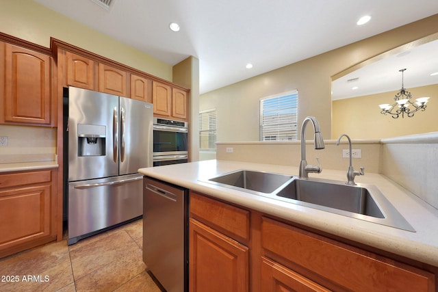 kitchen featuring recessed lighting, stainless steel appliances, a sink, light countertops, and decorative light fixtures