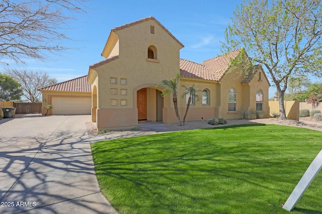 mediterranean / spanish house featuring a tiled roof, concrete driveway, fence, and stucco siding