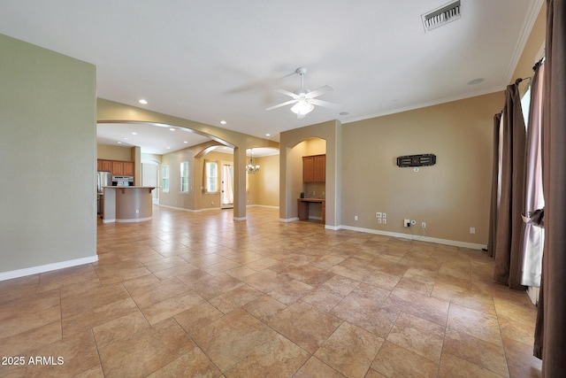 unfurnished living room with arched walkways, recessed lighting, visible vents, baseboards, and ceiling fan with notable chandelier