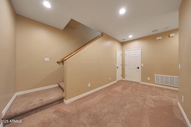 basement featuring carpet, recessed lighting, visible vents, baseboards, and stairs