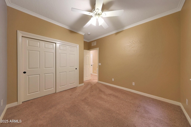 unfurnished bedroom featuring a closet, light colored carpet, and crown molding