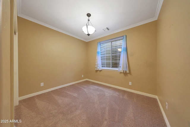 carpeted empty room with ornamental molding, visible vents, and baseboards