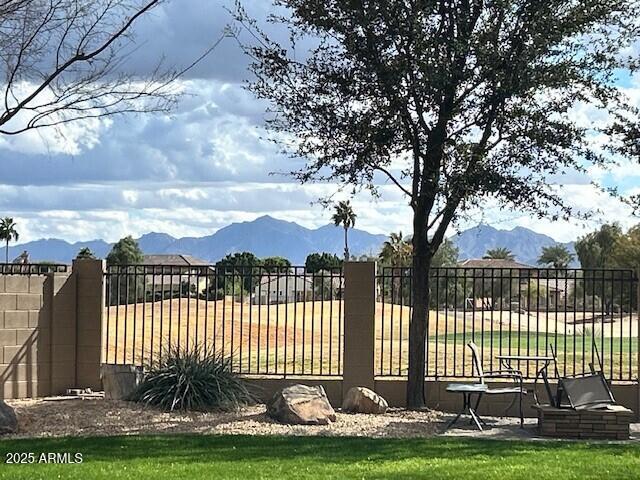 view of gate featuring fence and a mountain view