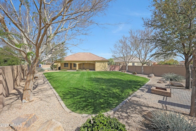 view of yard featuring a patio area and a fenced backyard