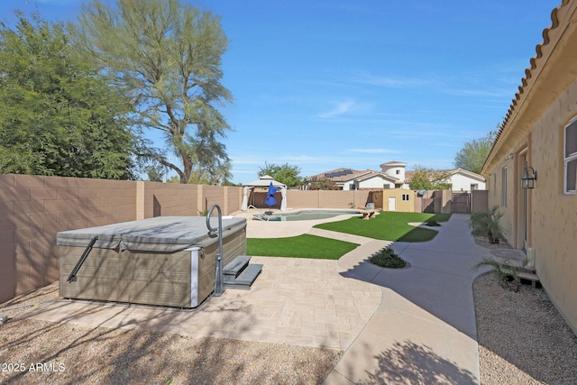 view of patio / terrace featuring a fenced backyard and a hot tub