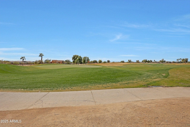 view of home's community with golf course view and a lawn