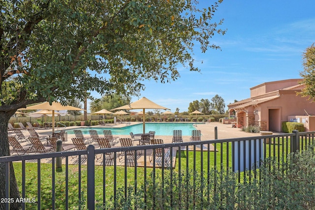 pool featuring a patio area, fence, and a lawn