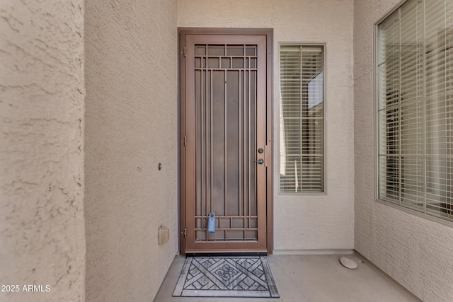 entrance to property with stucco siding