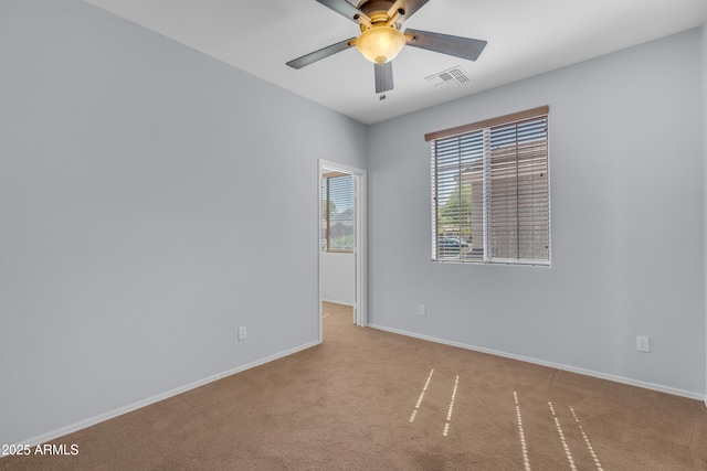 unfurnished room with baseboards, ceiling fan, visible vents, and carpet floors