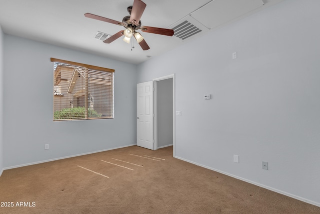 carpeted empty room featuring a ceiling fan, baseboards, and visible vents