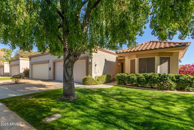 mediterranean / spanish-style home featuring a front yard and a garage